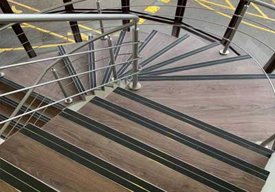 Various types of commercial stair nosings including slimline and heavy-duty profiles on display
