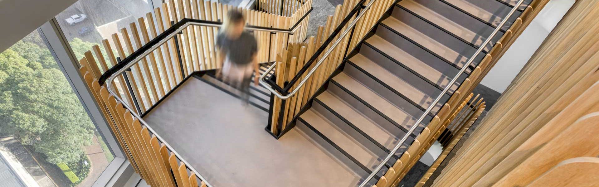 Installed stair nosings in a commercial building showing both slimline and heavy-duty options for enhanced safety and durability