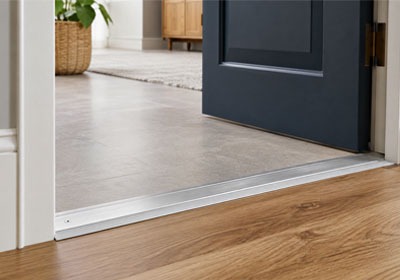 Door threshold being installed for safer and more durable doorway access