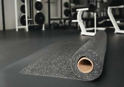 Stack of rubber mats and flooring tiles in various textures and thicknesses on display