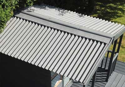 Close-up of modern plastic roof tiles in grey, showing texture and durability compared to traditional slate or clay