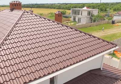Close-up of modern plastic roof tiles in grey, showing texture and durability compared to traditional slate or clay